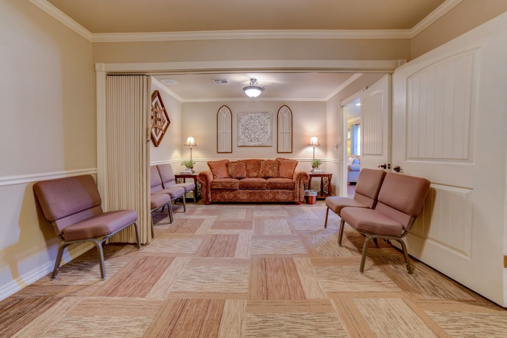 A living room with a couch and chairs in it.