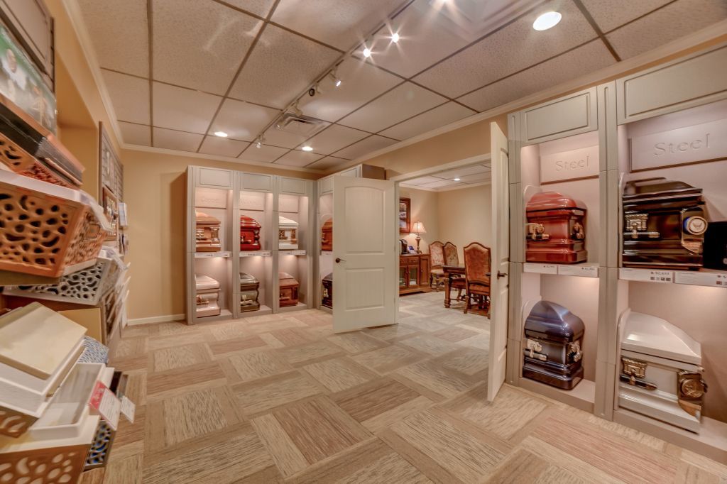 A room with a lot of shelves and coffins in it.