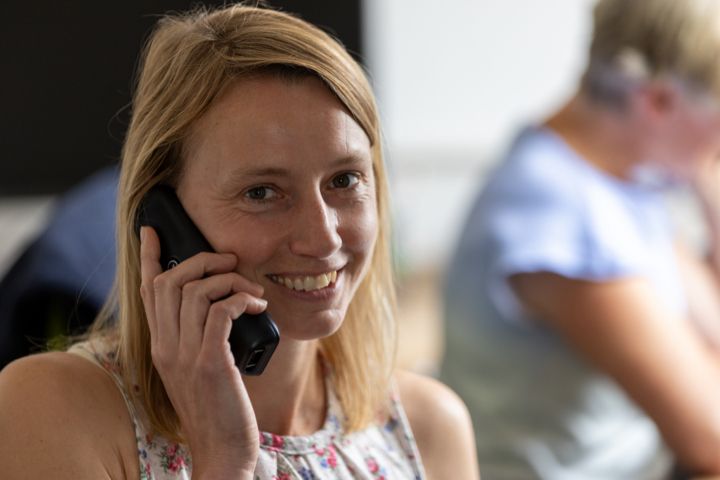 Chris Arnold Tree Surgery member Claire, a young fair skinned blonde woman on the phone