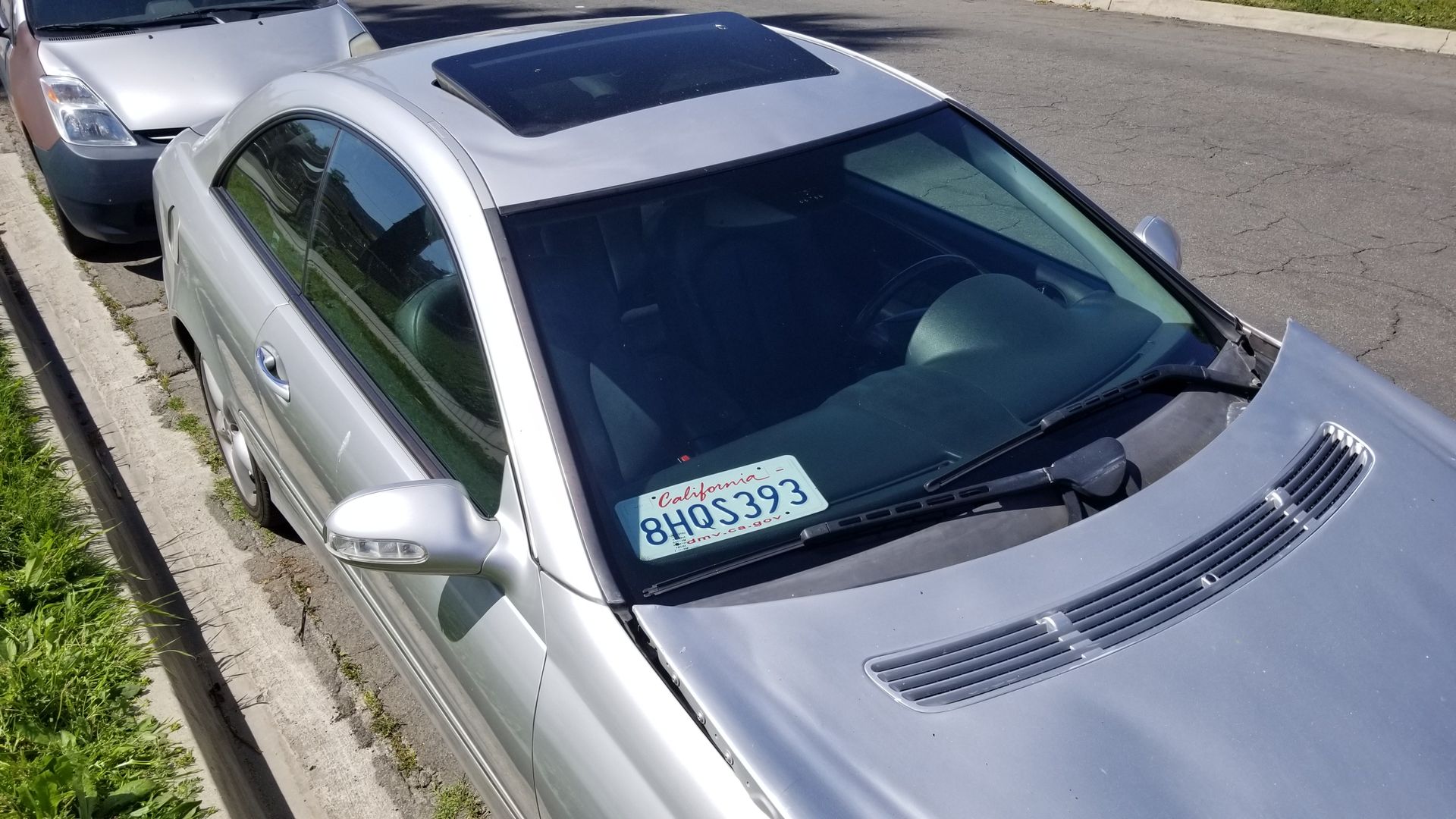 A silver car with a license plate that says bh04393