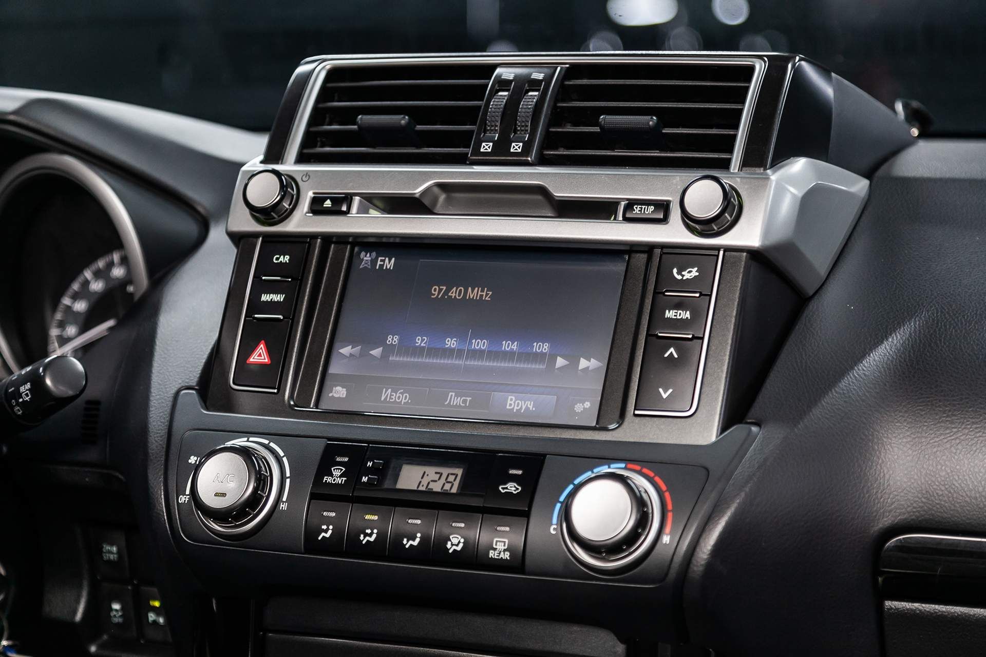 A close up of the dashboard of a car with a radio.