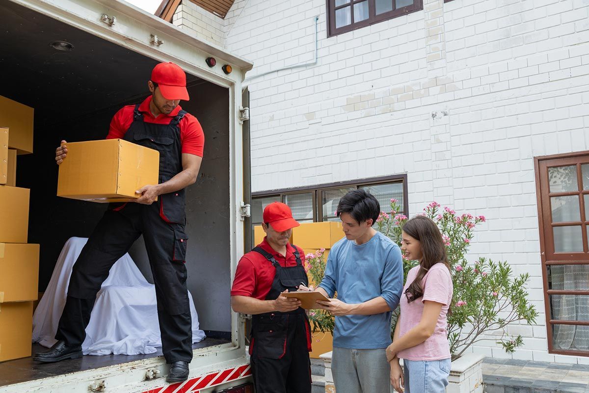 Professional movers carefully handling and transporting furniture during a residential move Professional movers carefully handling and transporting furniture during a residential move