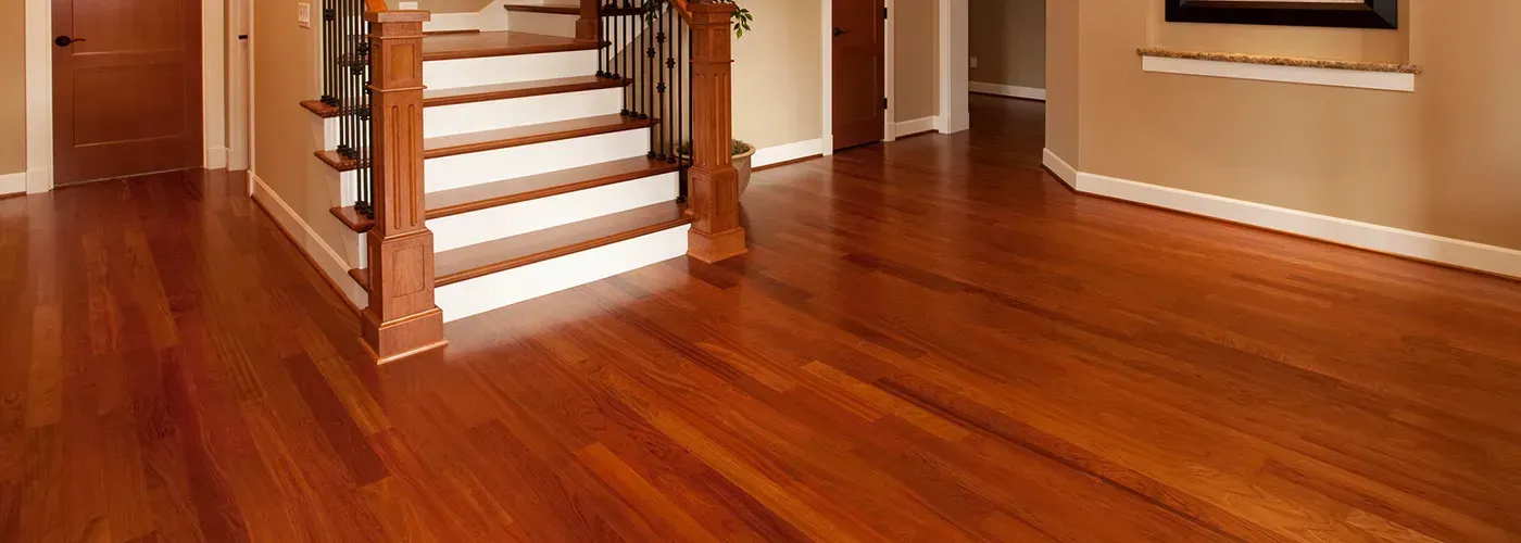 Wooden staircase and entryway with hardwood floors.