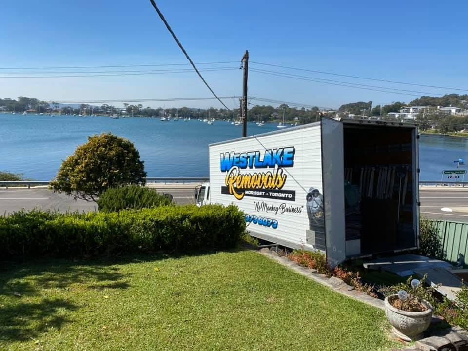 Moving Truck from West Lake Removals Parked Roadside, with Lake View — Westlake Removals in Doyalson, NSW