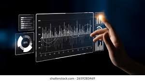 Hand touching a transparent screen displaying data charts and graphs, in a dark setting.