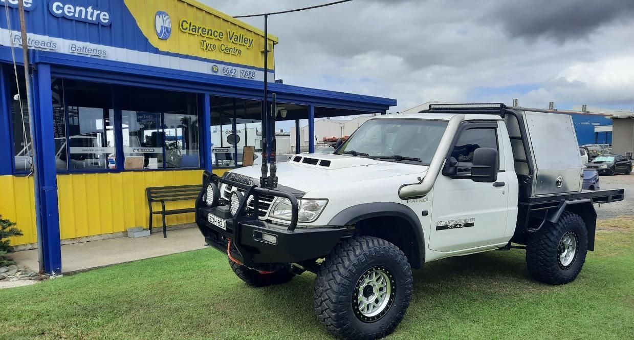 A Off-White Truck With A Business Premises Behind It — Clarence Valley Tyre Centre in South Grafton, NSW