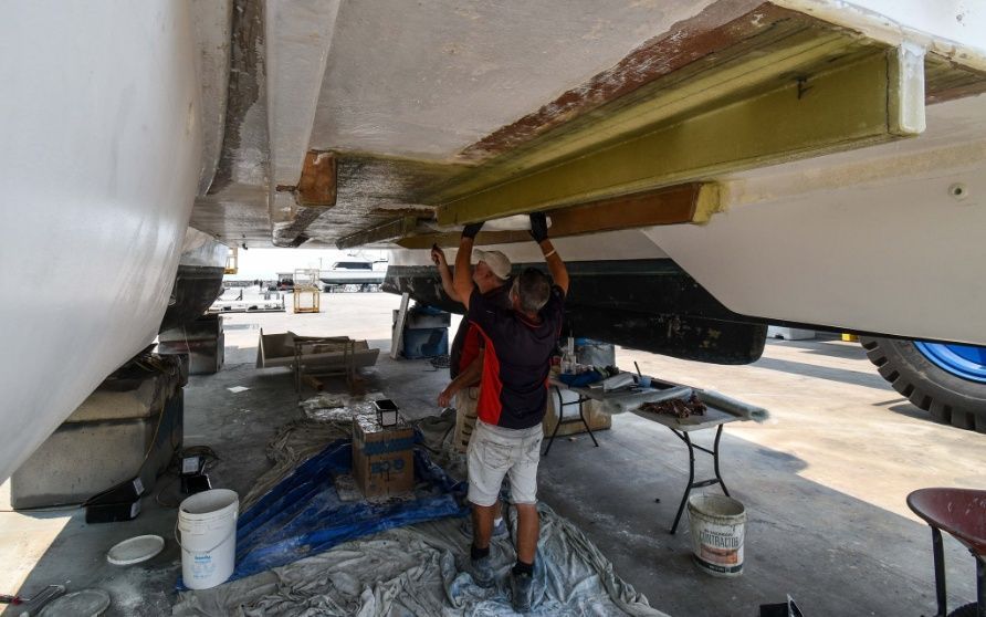 Two Men Are Working on the Underside of a Boat — Sandy Straits Marine In Urangan, QLD