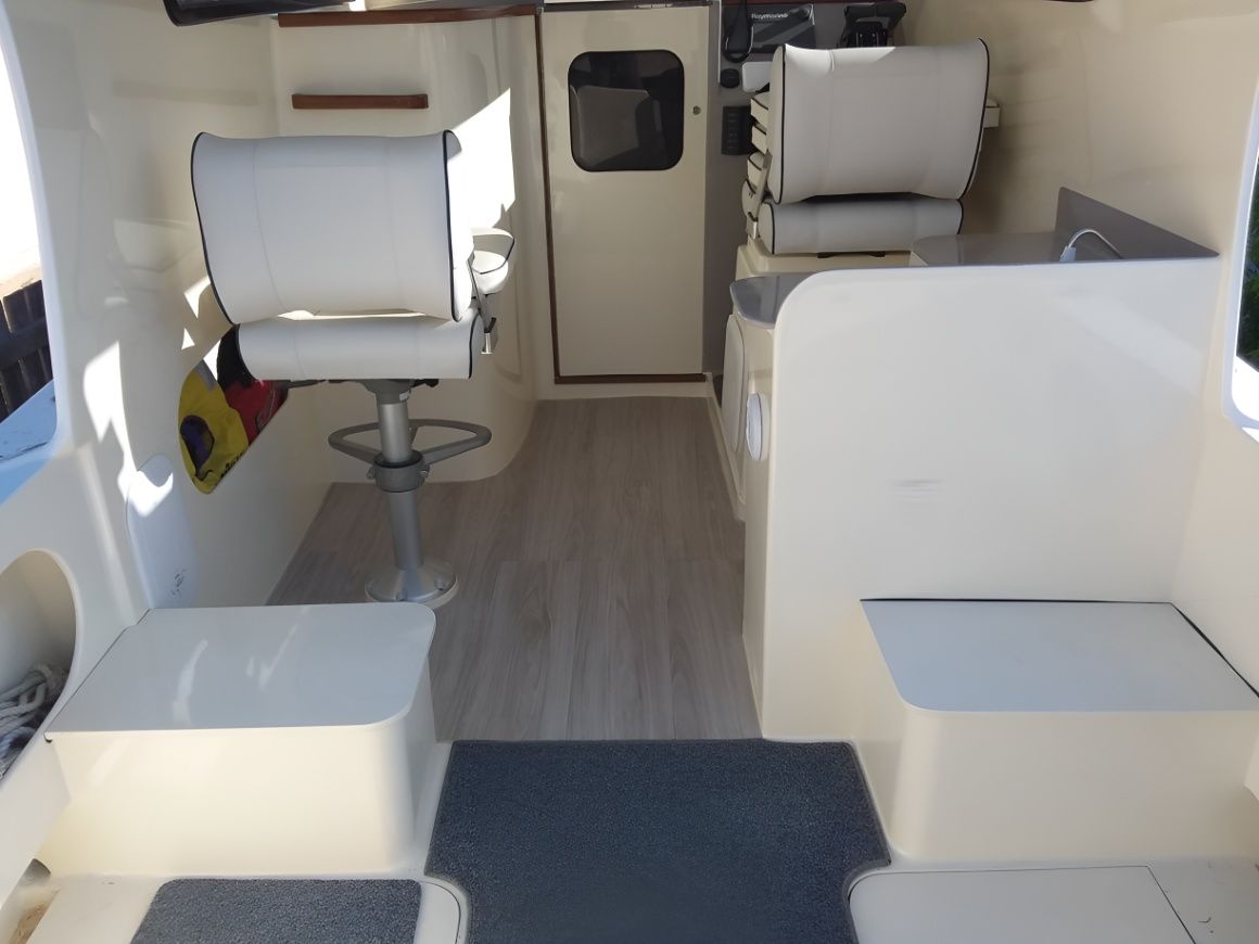 The Inside of a Boat With White Seats and a Door  — Sandy Straits Marine In Urangan, QLD