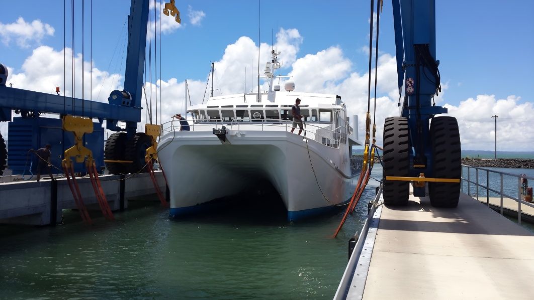 A Boat is Being Lifted Into the Water by a Crane — Sandy Straits Marine In Urangan, QLD