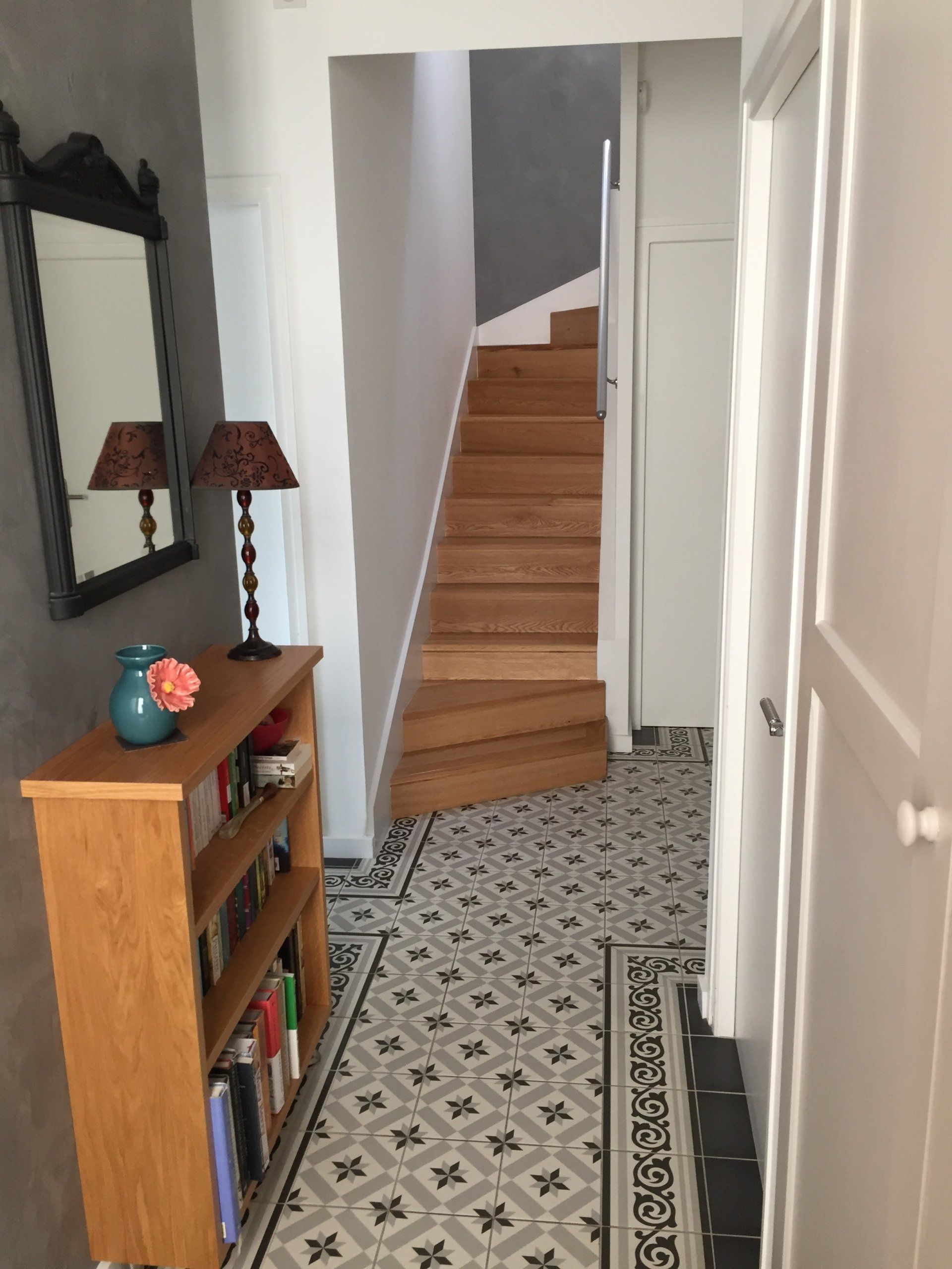A hallway with stairs leading up to the second floor