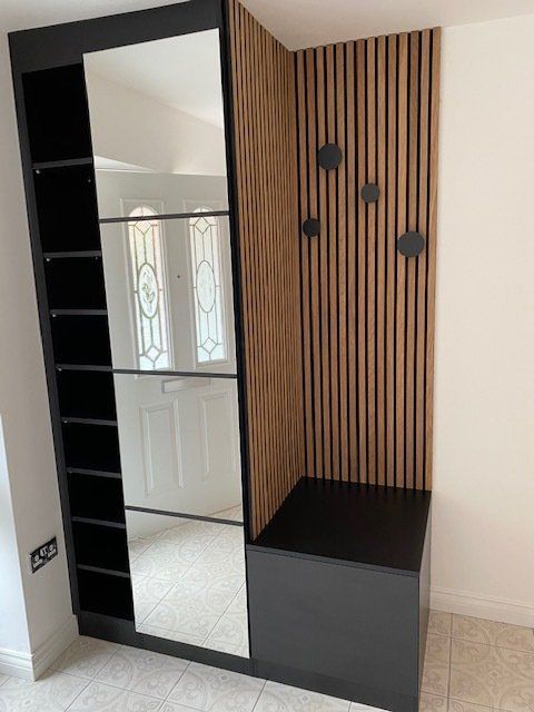 A closet with a mirror and a bench in a room.