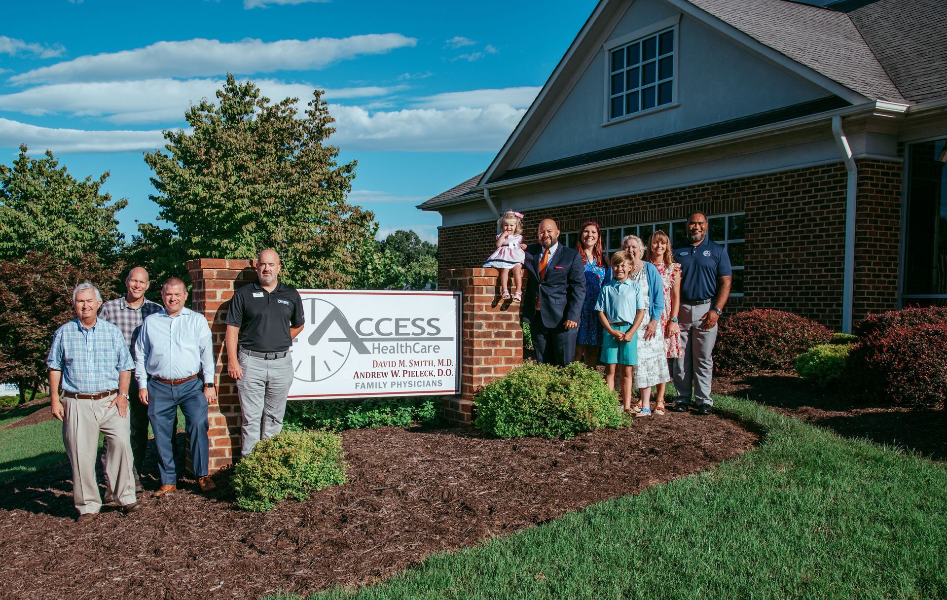 AHMG exterior sign with team members