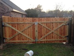 A wooden fence with a white bucket in front of it