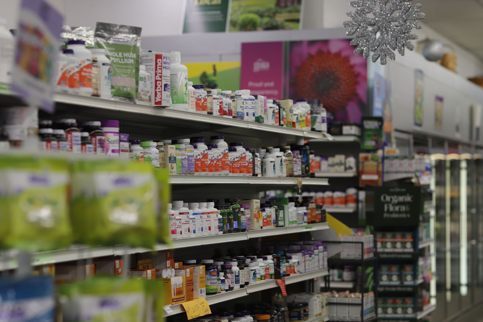 Shelves filled with various vitamins and health supplement bottles inside a retail store.
