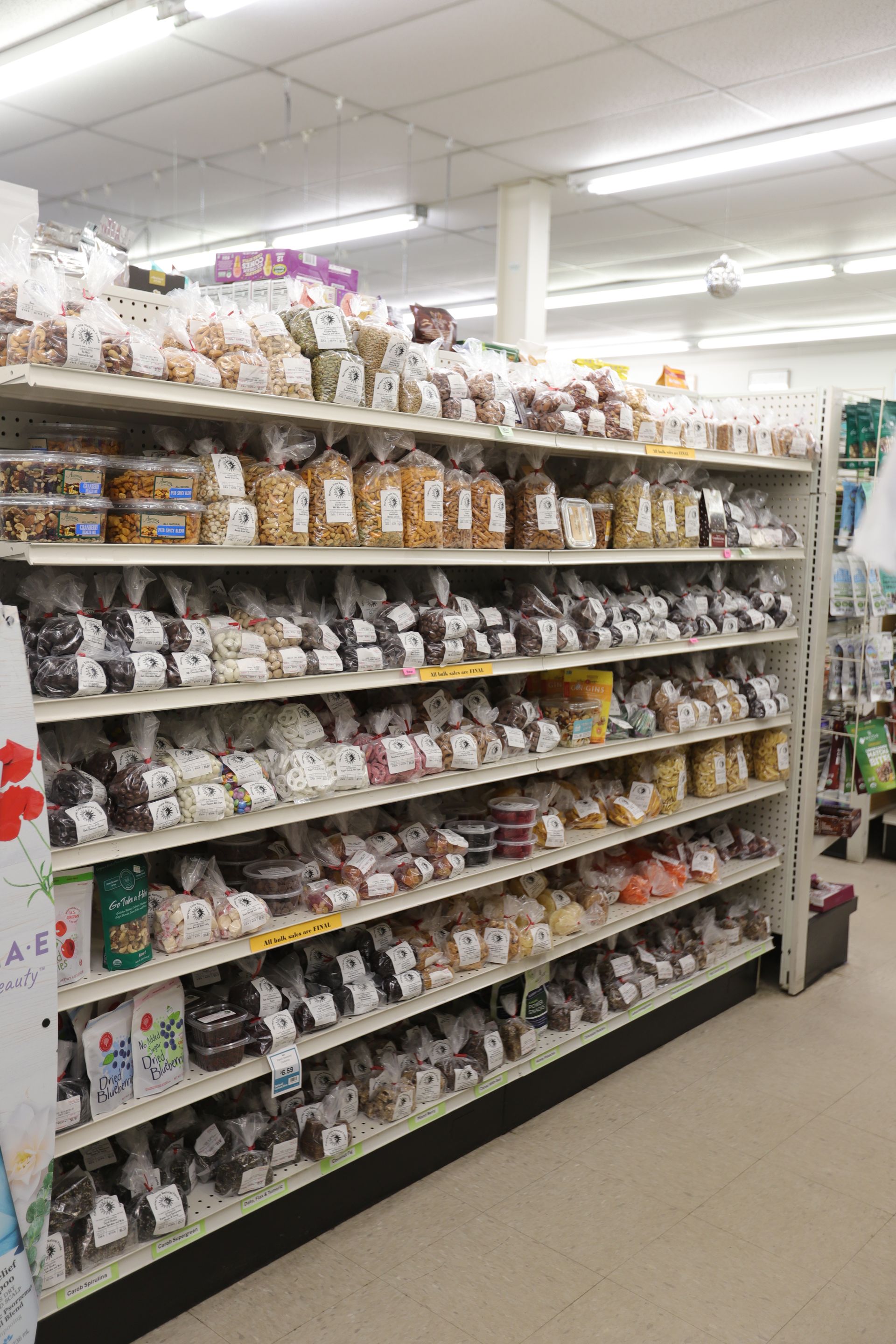 A store aisle featuring shelves stocked with various bagged snacks and baked goods.