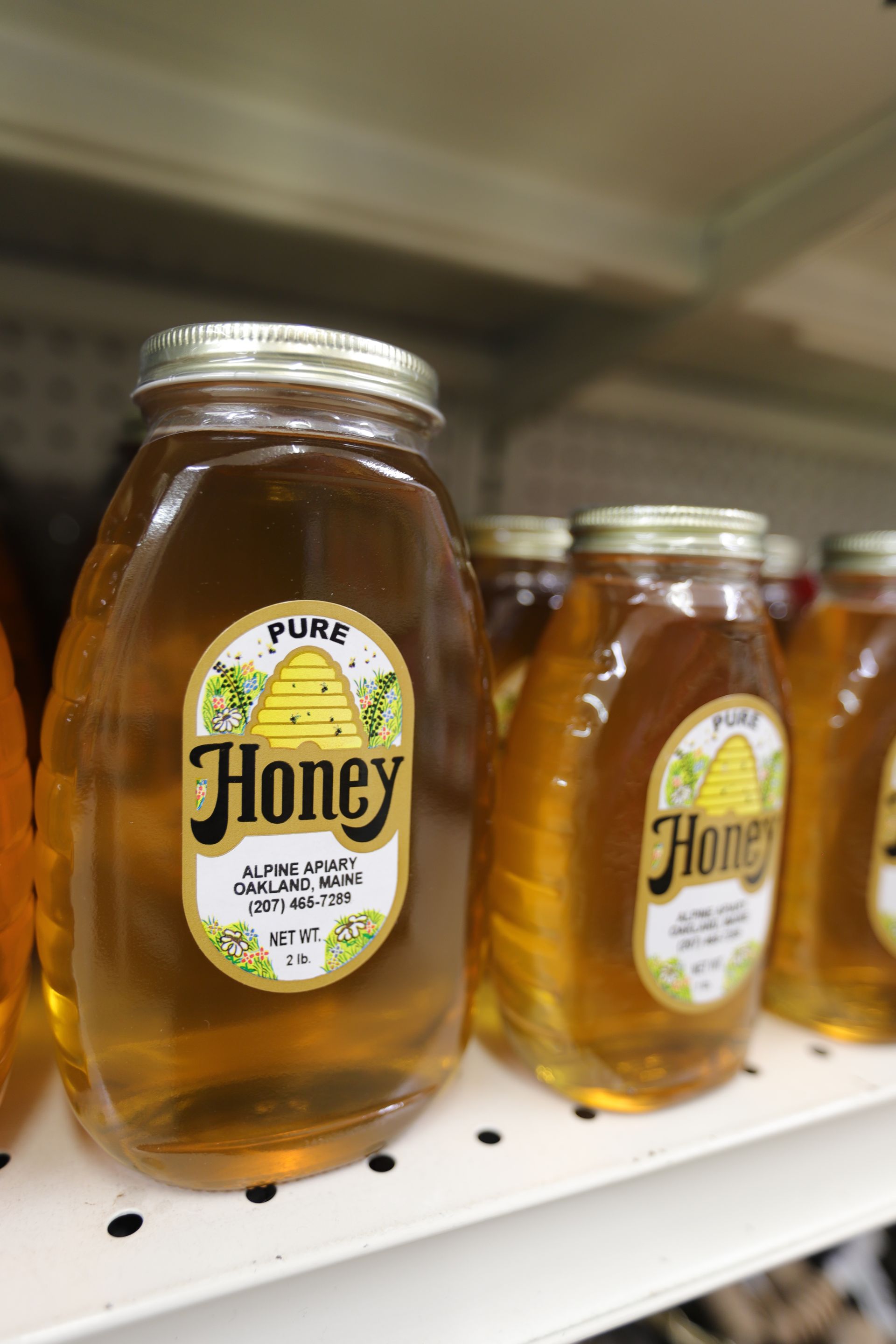 Glass jars of golden honey with 