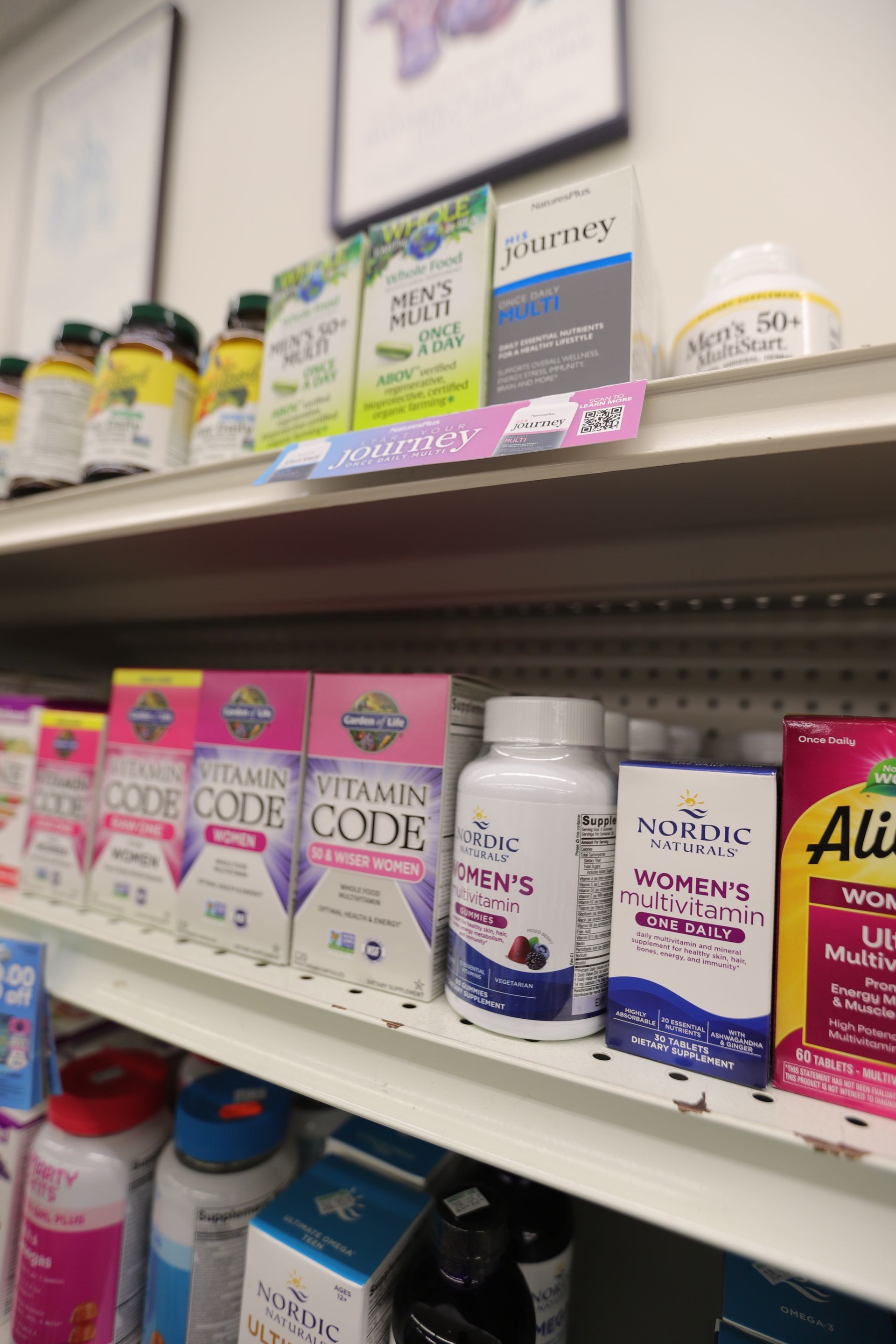 Shelves in a store filled with various boxes and bottles of vitamins and health supplements.