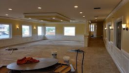 Empty room with yellow walls, white trim, and recessed lighting, appearing under construction.