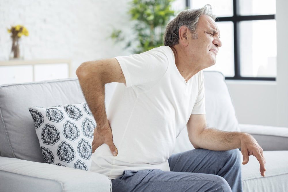 Sunrise Hospital. Patient-107. Stock photo of man with back pain.
