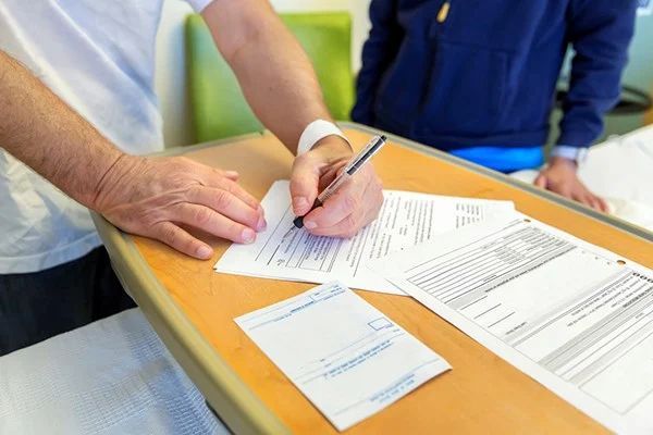 Sunrise Hospital. Stock photo of man signing the AMA form. Sunrise Hospital. Stock photo of man signing the AMA form.