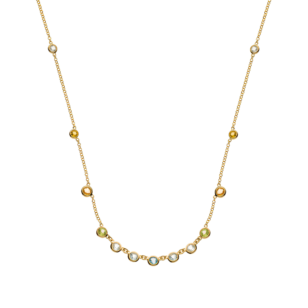 Collier de perles dorées avec une rangée incurvée de pierres blanches et vertes sur fond blanc