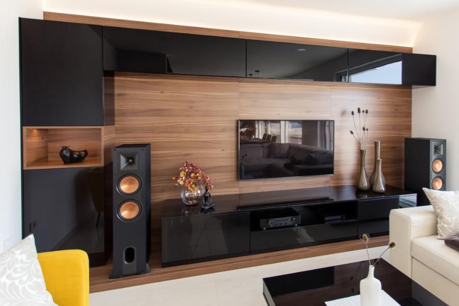 A living room with a flat screen tv and speakers.