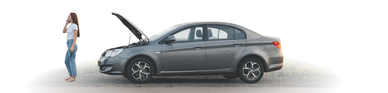 A person standing near a gray sedan with its hood open, appears to be on the phone | I-75 Auto Repair and Towing