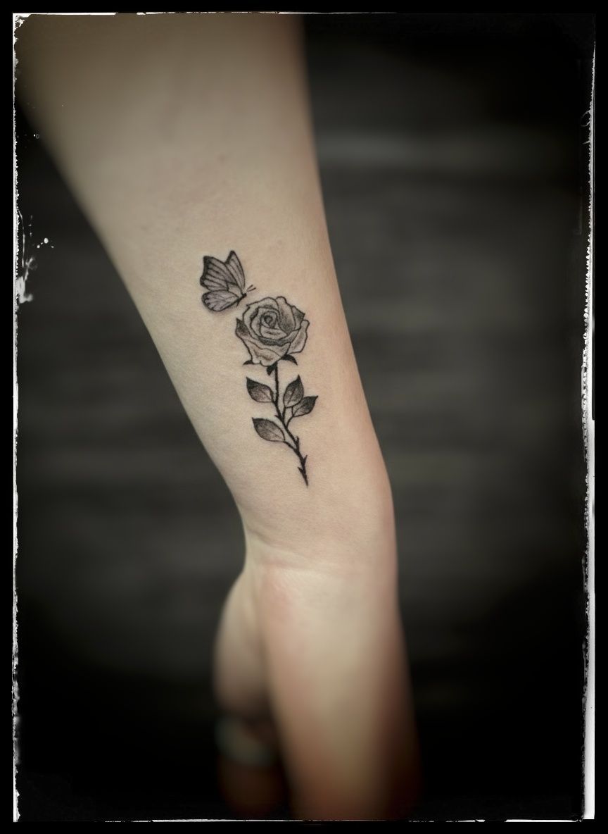 Black & grey rose with little butterfly.
 Tattoo by Thomas at HD Ink Tattoos, Bathgate , West Lothian.