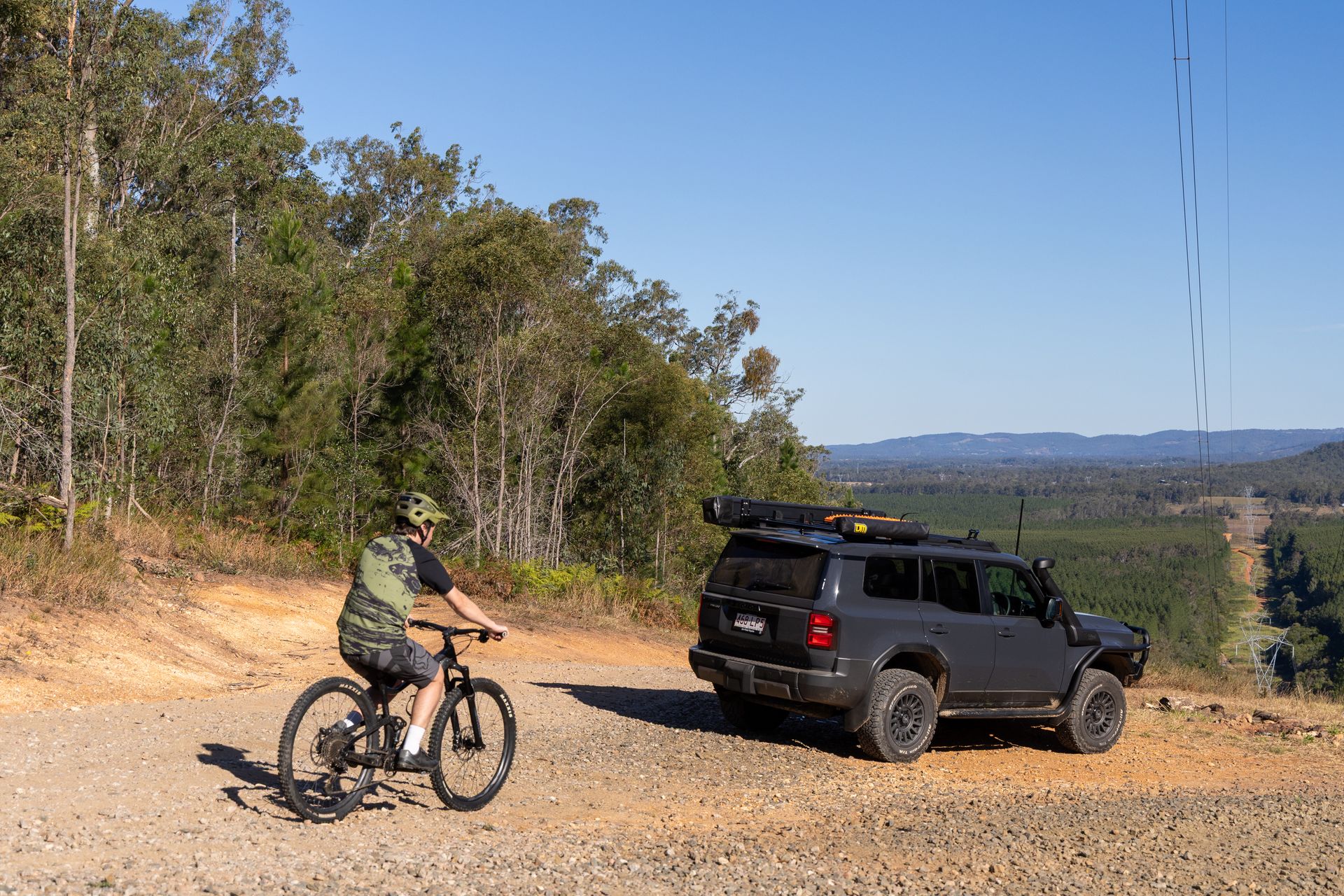 A Man And A Woman Are Standing Next To A Silver SUV With The Trunk Open — TJM Dubbo In Dubbo, NSW