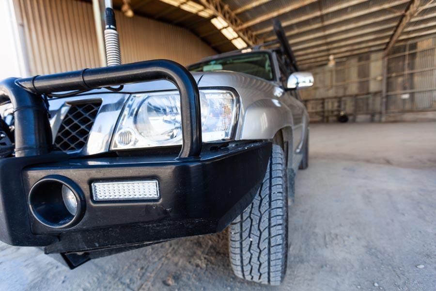 4WD equipped with bull bar, snorkel, and off-road tyres parked in a shed for Dubbo bush adventures.