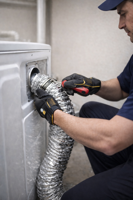 Technician repairing a dryer vent in a home