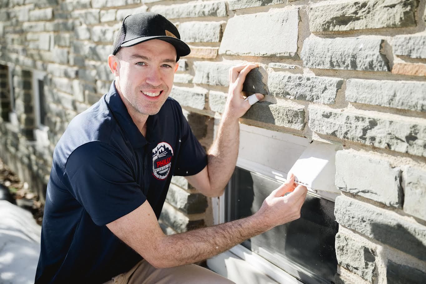 Technician cleaning a dryer vent from outside of home