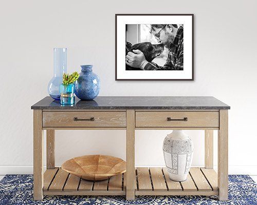 Rustic console table with decor, a basket, and framed black-and-white art against a white wall in a Westfield, IN home.