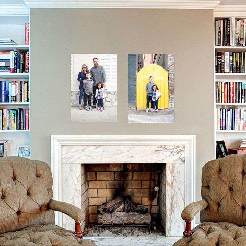 Living room fireplace with two framed family photos on the mantel wall, flanked by bookshelves in Carmel Indiana