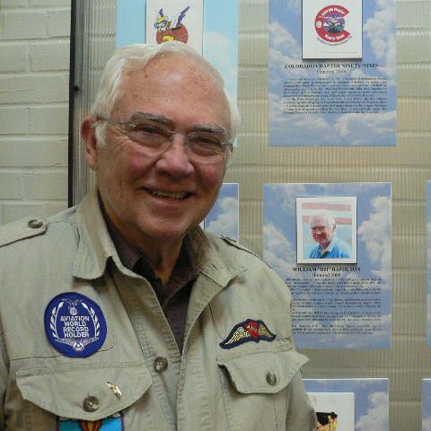 A man wearing a jacket with a badge that says ' a ' on it