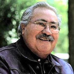 A man with glasses and a mustache is smiling for the camera.