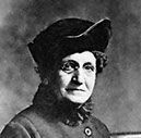 A black and white photo of a woman wearing a hat.