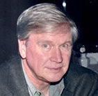 A man in a suit and tie is smiling for the camera.