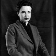 A black and white photo of a young woman in a suit.