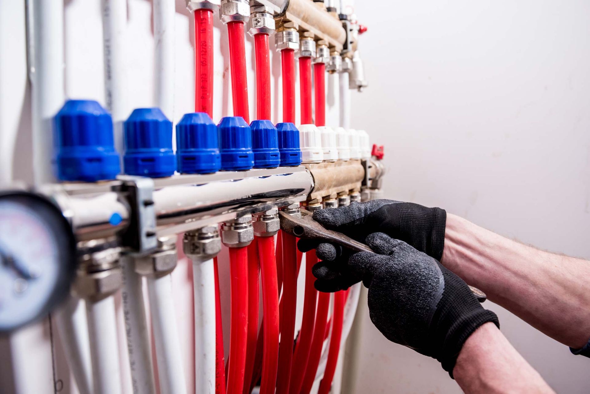 A Person Is Working On A Heating System With A Wrench — Rome, GA — Crider Plumbing Co A Person Is Working On A Heating System With A Wrench — Rome, GA — Crider Plumbing Co