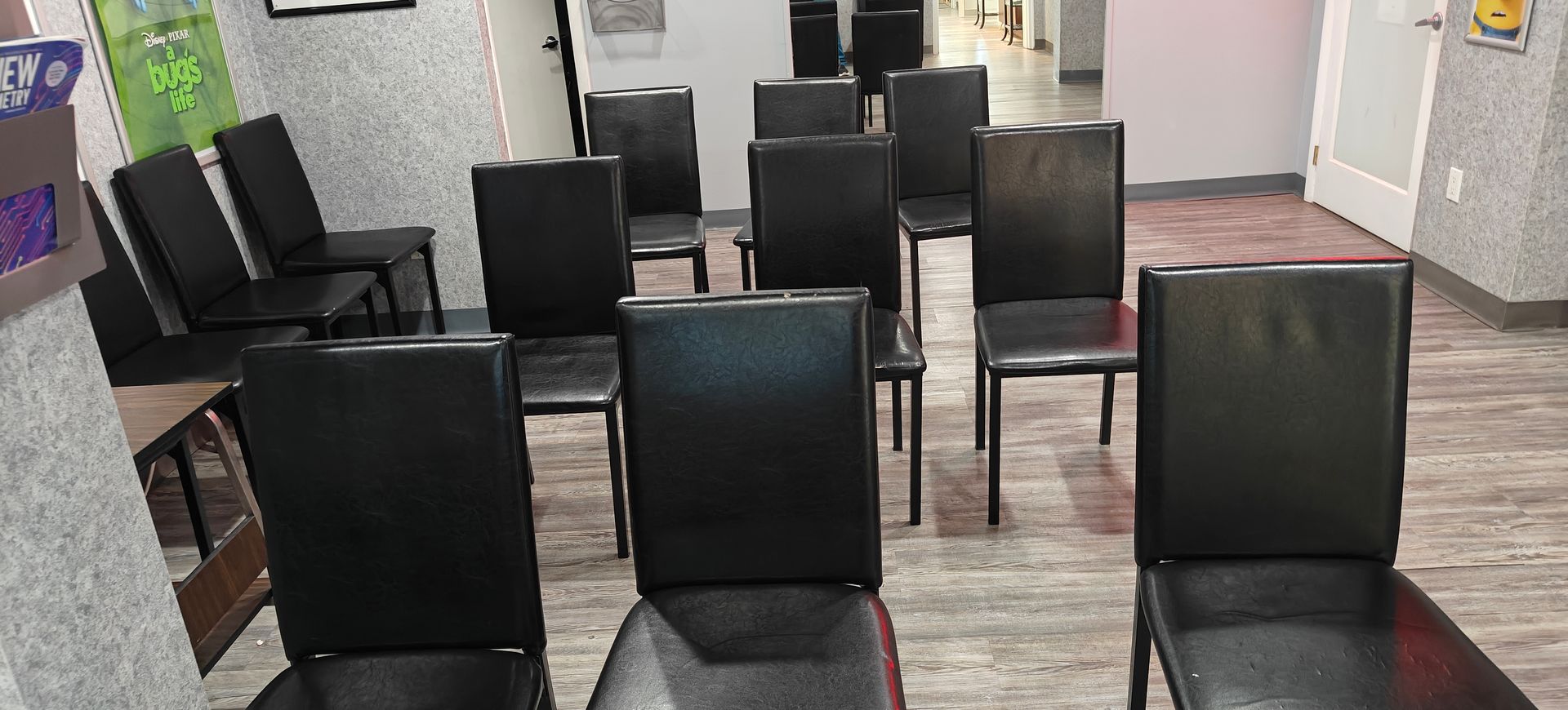 A room with rows of black chairs.