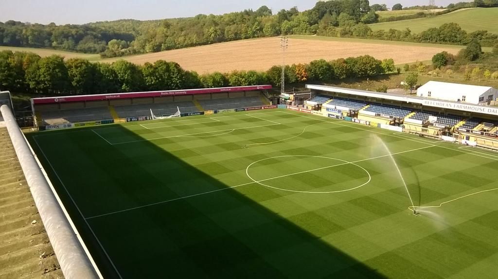 A soccer field with a sprinkler spraying water on it
