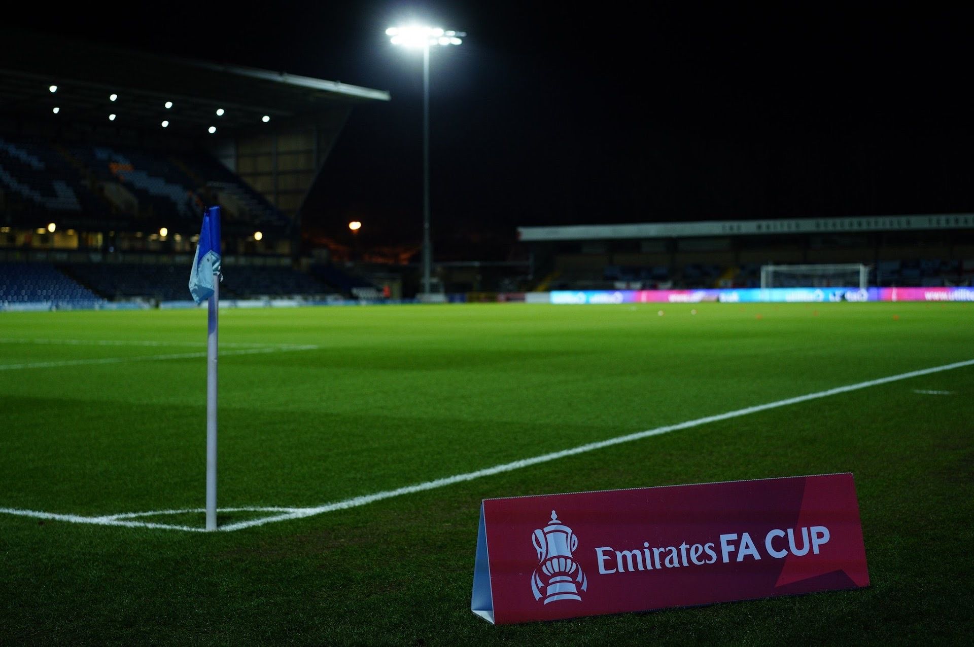 A soccer field with a sign that says emirates fa cup