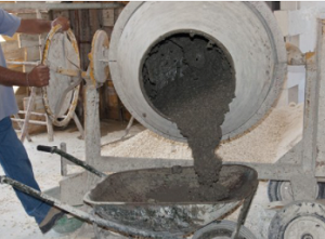 Concrete mixer pouring out in wheel barrel to be dumped for sidewalk in Cheyenne.