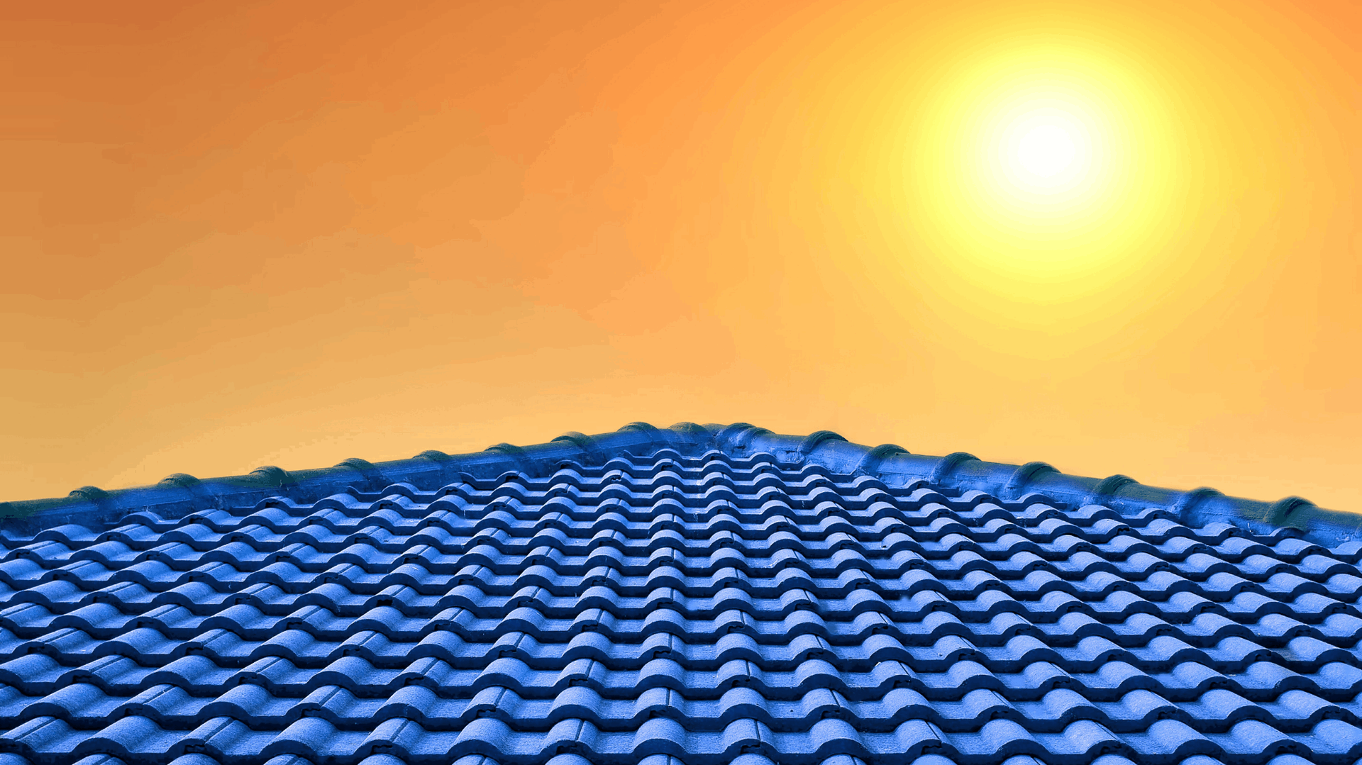 Blue tiled roof under a bright yellow sun in a clear sky — C&A Roofing In Tweed Heads, NSW