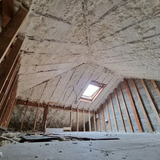 A room with a window and a lot of foam on the ceiling.