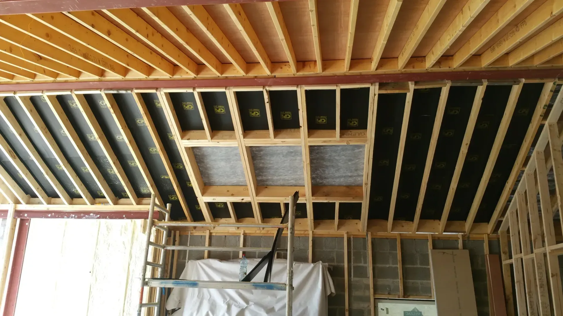 A ladder is in the middle of a building under construction