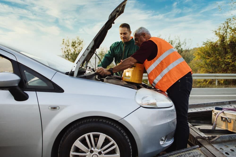 Two Men Are Working On A Broken Down Car On The Side Of The Road — Manning Smash & Auto Repairs In Wingham, NSW