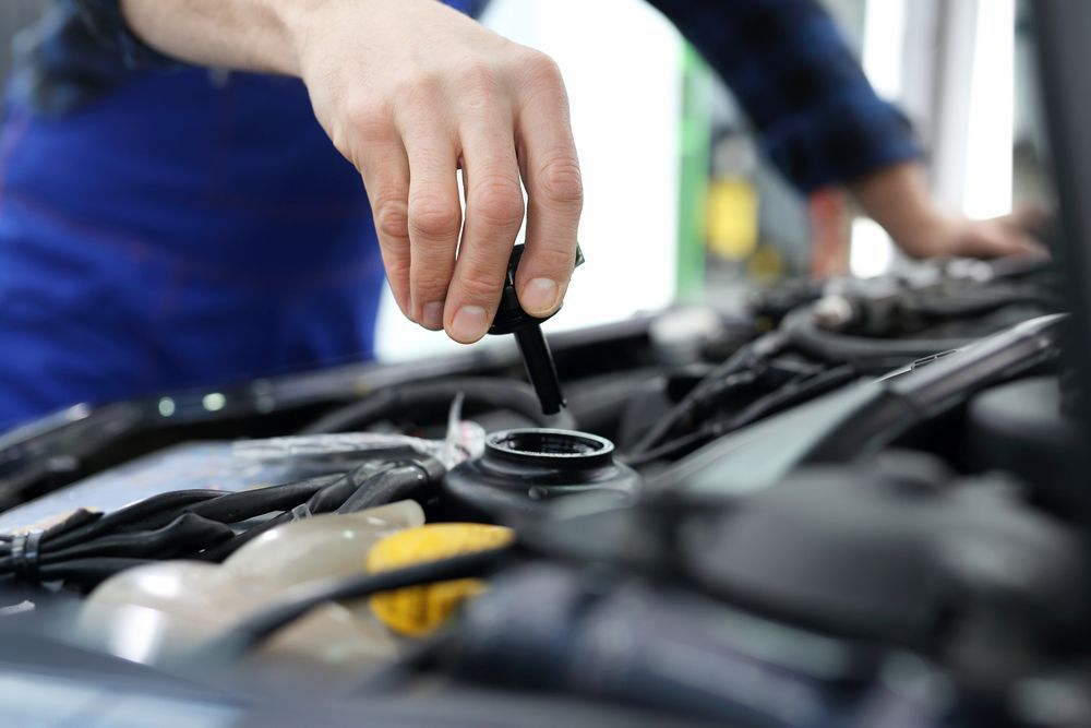 A Close Up Of A Person Checking A Car Engine — Manning Smash & Auto Repairs In Wingham, NSW