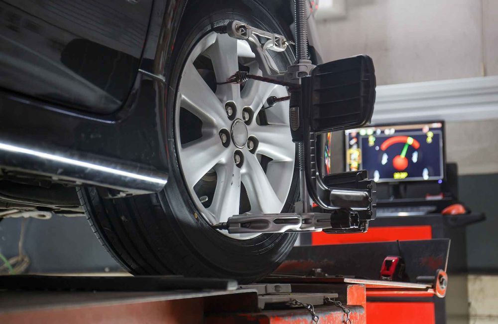 A Car Is Being Aligned On A Machine In A Garage — Manning Smash & Auto Repairs In Wingham, NSW
